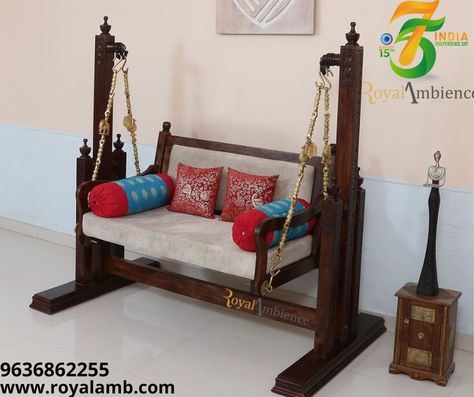 This wooden swing with delicate carving and well-thought & conceptualized design been the point of attraction since the beginning. Move it in a hallway, living room, or porch or may be outdoor with some cover to protect it from rain. Bearing for smoother swing movement strong leg support from stability. Crafted by matured craftsmen with assorted and treated timber - Sheesham wood, hand-waxed premium polish. Decorated brass chains add real charm. #woodenswing #FreeStanding #freestandswin Indian Living Room Decor Ideas, Wooden Jhula, Swing In Living Room, Wooden Stool Designs, Balcony Swing, Indian Living Room Decor, Garden Path Lighting, Living Room Indian, Wooden Living Room Furniture