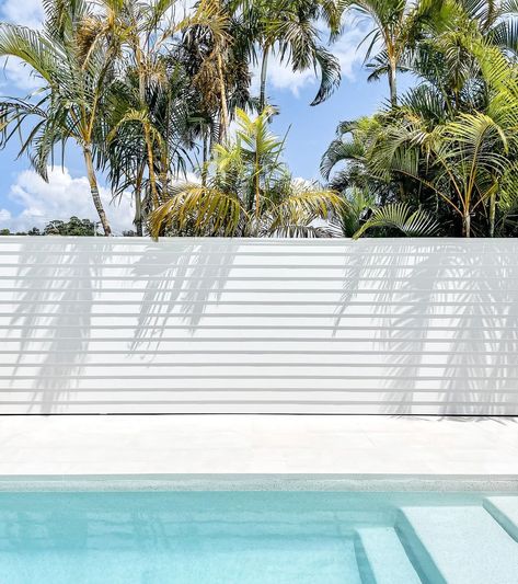 Dilly Shack on Instagram: “Here it is, in all its glory! Our feature wall by the pool, finally painted and creating the perfect backdrop for shadow play on a sunny…” Pool White Fence, Pool Walls Ideas, Pool Cladding Ideas, Pool Screening Ideas, Pool Screen Privacy Ideas, Swimming Pool Feature Wall, Pool Privacy Wall, White Pool Area, Pool Wall