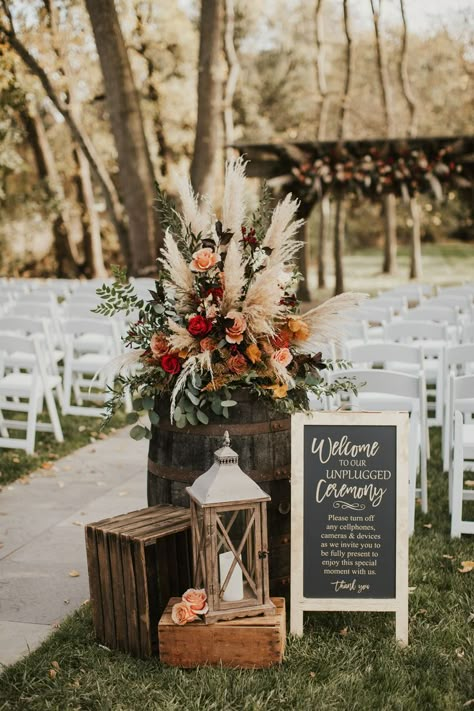 Photo of wedding floral arrangement in fall colors, including pompas grass, red flowers and rust color flowers. Fall Wedding Ceremony, Western Themed Wedding, Wedding Isles, Wedding Aisle Decorations, Outdoor Wedding Ideas, Wedding Entrance, Wedding 2025, Fall Wedding Decorations, Fall Wedding Colors