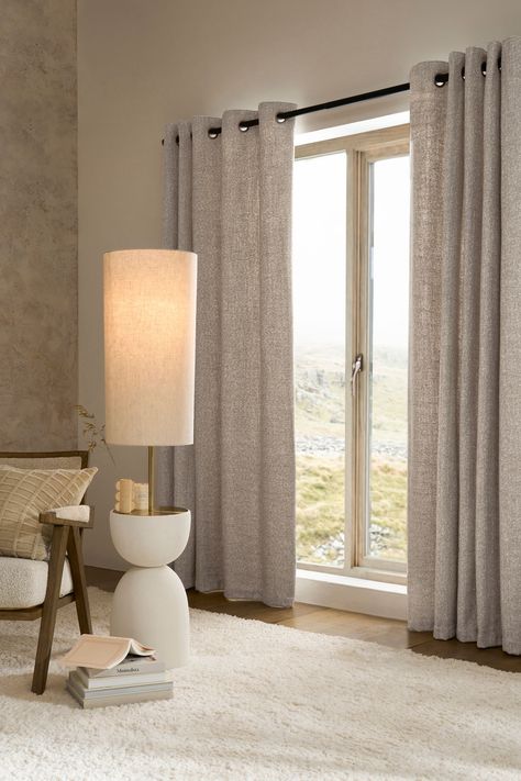 In a textured cosy fabric, these curtains are the perfect addition to any room in your house. The heavyweight fabric drapes beautifully and feels tactile and cosy. Simple silver brushed eyelets make them easy to pair with your existing or chosen curtain pole. The standard lightweight lining adds an extra layer to the back of curtains to provide added durability and to help prevent fading over time. Or, beat the chill and keep your home warm and cosy with our super thermal lining. For top tips on Beige Curtains Living Room, Lounge Curtains, Lounge Room Styling, Neutral Curtains, Curtains Living Room Modern, Window Curtains Living Room, Beige Curtains, Simple Curtains, Eyelet Curtains