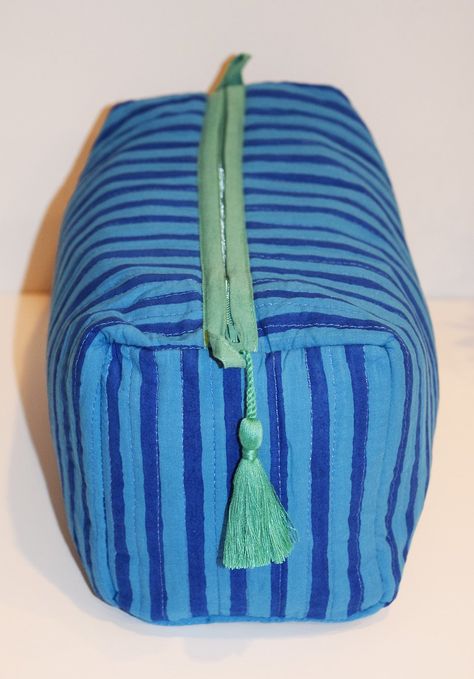 Our largest toiletry bag is gorgeous and functional. Fully lined with waterproof material + 4 interior pockets. Zipper closure with tassel trim. 100% cotton with decorative stitching 11" L x 5.5" H x 5" W YKK zipper closure with tassels Spot clean or machine wash on delicate cycle, cold water, inside laundry bag. Air dry. Sew Laundry Bag, Large Toiletry Bag, White Boho Tops, Creative Textiles, Diy Bag Designs, Travel Toiletry Bag, Laundry Bags, Minimalist Bag, Decorative Stitching