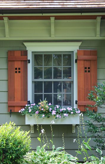 CURB APPEAL – another great example of beautiful design. Cape cod home renovated into craftsman style home. The homeowners of a 1930s cape-style home that had been remodeled and expanded several times before they purchased it wanted an exterior face lift that would upgrade and unify the home's aesthetics while adding much needed functionality. Shutters And Flower Boxes, Simple Shutters, Shutters Diy, Framed Windows, Cape Style Homes, Green Window, Exterior Window, House Shutters, Garden Window