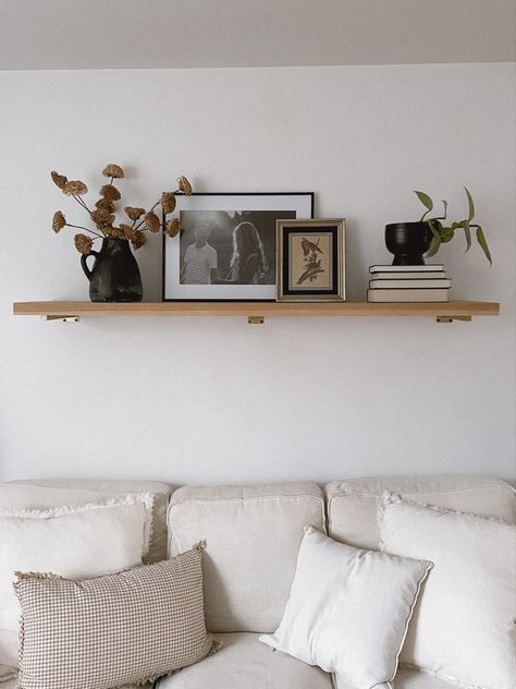 Simple Living Room Shelf Decor, Large Living Room Shelf, Floating Shelf Above Credenza, Floating Mantle Above Couch, Floating Shelf Wall Sconces, Single Shelf Styling Living Room, Two Shelves Above Couch, Long Shelf Above Couch Modern, Styling A Floating Shelf