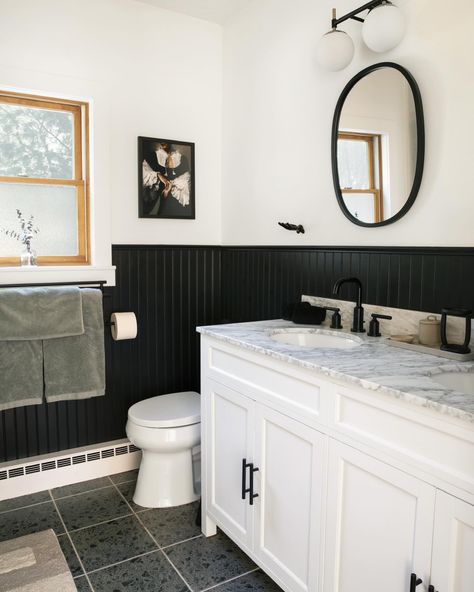 Since I’m on the bathroom train, let’s talk about one of the bathrooms in our Catskills mountain house that I designed. When we first walked the house in ‘21, we were told that the one bathroom in the house was “tastefully updated”. I use air quotes because you never know what people consider tasteful. Suffice to say, tasteful it was not. Yes, installation was new, but they installed floor to ceiling large format tiles from the 80’s. Everything was screaming, “why did you install me” and I kn... Black Panel Wall Bathroom, Black Panelling Bathroom, Black Board And Batten Bathroom, Black Beadboard Walls, Black Beadboard Bathroom, Panel Wall Bathroom, Black Wainscoting Bathroom, Black Trim Bathroom, Black Wall Bathroom