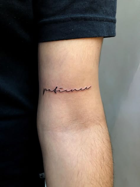 Patience tattoo above elbow. Bicep tattoo. Handwritten. Aesthetic. Aesthetic tattoo. Tattoo for lean people. Patiencs tattoo. Bicep Writing Tattoo, Hineni Tattoo, Above Elbow Tattoo Words, Bicep Word Tattoo, Small Bicep Tattoo Men, Lower Bicep Tattoo, Small Bicep Tattoo, Word Tattoos Men, Front Bicep Tattoo