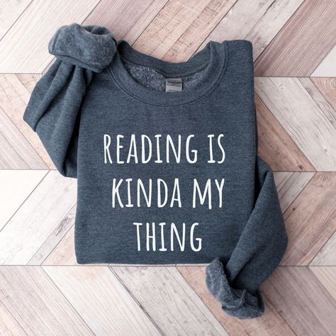 (Library Shirt Librarian Shirt Funny Librarian Shirt Book Lover Librarian Gift School Librarian Gift Book Reading shirt Librarian Gift The Book Was Better Library Tshirt Bookish Funny Reading Shirt Book Shirt Librarian Gifts Cute Graphic Tees Trending Now) Elevate your everyday pullover with our Reading Is Kinda My Thing Book sweatshirt.  Made from a breathable, luxuriously soft fabric with a premium printed design. Featuring a crewneck style and a relaxed, lightweight fit for a comfort that goe Bookish Tshirt Ideas, Bookish Shirts, Library Tshirt, Reading Humor, Librarian Shirt, Book Clothes, Book Tshirts, Reading Shirts, Cute Graphic Tees