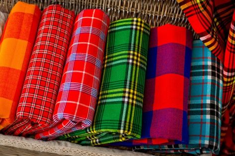 Colorful plaids of the masai tribe. afri... | Premium Photo #Freepik #photo #background #blue-background #gift #green African Table, Mall Ideas, Masai Tribe, Curio Shop, Maasai Shuka, Cloth Patterns, Blanket Picnic, Blanket Shawl, Kente Cloth