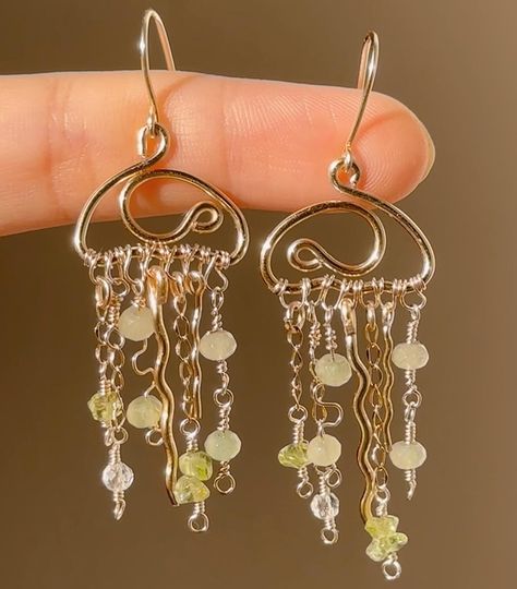 it’s the season of change!! i really want to try something new for the rest of the year, i want to make more intricate earrings and pendants which will all be limited pieces, like this jellyfish! hope you love these pieces x These super cute earrings are for ₹799! Prehnite and Peridot Crystals I’m so excited about the next few drops, can’t wait to post them🤍 #wirejewelleryindia #namenecklaceindia #mysteryboxindia #wireearrings #wireearringsindia #wireworkjewelry #smallbusiness #smallbusine... Wire Wrapped Dangle Earrings, Mushroom Wire Earrings, Mushroom Wire Art, Wire Mushroom Earrings, Metal Wire Earrings, Wired Wrapped Jewelry Diy, Gold Wire Earrings, Earrings Making Ideas, Homemade Earrings Ideas