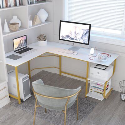 This clean-lined L-shaped desk offers a sleek industrial look and a modern, mixed-material design. The frame is crafted from steel and the tabletop and two convenient shelves are made from engineered wood in a striking hue. Designed for multi-purpose use, this desk is ideal for gaming, working from home, or writing the next great novel. Plus, it even boasts reversible orientation, so it's easy to incorporate into spaces of all configurations. Color (Top/Frame): White/Gold, Size: 29.3" H x 61" W L Shape Desk, Wood Computer Desk, Desk Wood, Bookshelf Storage, Office Guest Room, Office Inspo, Corner Table, Austin Design, L Shaped Desk