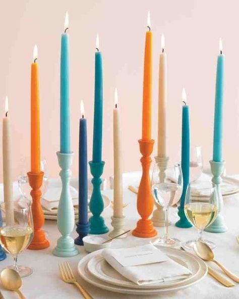 Try a modern twist at your Thanksgiving table with a variety of bright colors, like blues and warm orange tones! Colored Candlesticks, Colorful Candle Holders, Affordable Wedding Centerpieces, Modern Thanksgiving, Coloured Candles, Wedding Centerpieces Diy, Wedding Ceremony Ideas, Martha Stewart Weddings, Diy Centerpieces