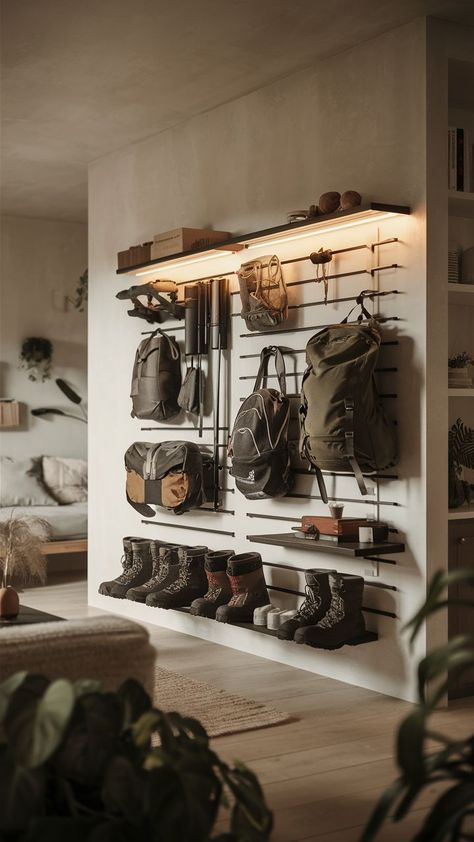 A minimalist room with a sleek camping gear wall, organizing outdoor adventure gear in a clean, simple way. Hiking Gear Storage Ideas, Saddle Storage Ideas, Gear Wall Storage, Outdoor Gear Room, Climbing Gear Organization, Gear Room Ideas, Outdoor Gear Organization, Fitness Equipment Storage, Outdoor Gear Storage