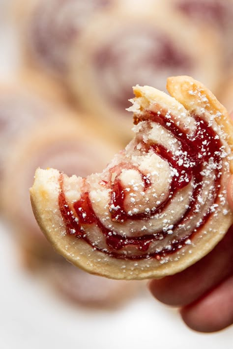 These cream cheese jam pinwheel cookies are airy, light and buttery with a sweet raspberry jam. Cream cheese dough and jam are swirled together to make a beautiful Christmas design. Sprinkle them with a little powdered sugar to look like snow. Cherry Pinwheel Cookies, Cranberry Pinwheel Cookies, Shortbread Cookie Logs, Pin Wheel Cookies Recipe, Cream Cheese Dainties, Cinnamon Pinwheel Cookies, Christmas Cookies Slice And Bake, Cookies With Strawberry Jam, Cookie Party Recipes