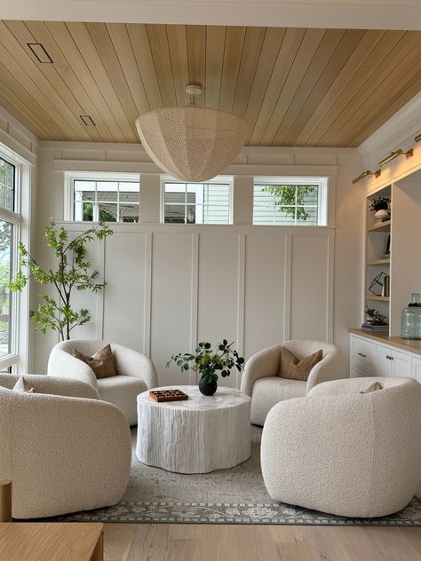 Everything about this cozy sitting room space is absolutely breathtaking...from the board and batten creamy white walls, the unique windows, the oak paneling on the ceiling, the wall of built-ins, we couldn't love it more! To top it off, the room is styled to perfection and is surely a space that you would want to spend endless amounts of time in!   New Construction | Home Trends 2024 | Home Design | Minnesota Home Trends 4 Armchairs Sitting Room, Front Room Office And Sitting Area Cozy, Chair In Front Of Tv, Upstairs Sitting Room Ideas, Home Seating Area, Guest Room Sitting Area, 4 Chairs Sitting Area Sunroom, Open Den Room Ideas, Modern Farmhouse Sitting Area