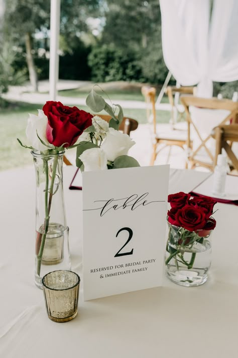 Wedding Decor With Red Roses, Red White Centerpieces Wedding, Romantic Dinner Centerpiece, Red Table Numbers Wedding, Minimalist Red Wedding Decor, Red Rose Wedding Reception Decor, One Rose Centerpiece, Red And White Theme Wedding, Burgundy And White Wedding Centerpieces