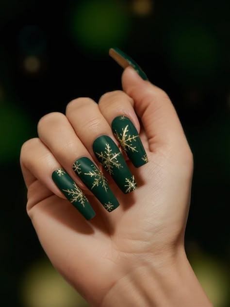 Matte forest green nails are adorned with stunning golden snowflakes, creating a festive and luxurious design. This look is perfect for the holiday season with its rich tones and intricate winter detailing. Matte Green And Gold Christmas Nails, Forest Green Holiday Nails, Christmas Nails Forest Green, Green And Gold Nails Square, Christmas Green And Gold Nails, December Nails Green And Gold, Forest Green Gold Nails, Golden Green Nails, Green Nails With Gold Design