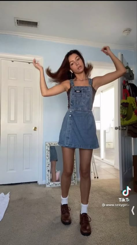 Jean Dress Overall Outfit, Denim Overalls Dress Outfit, How To Style Overall Dress, Overall Skirt Outfit Fall, Black Skirt Overalls Outfit, Overall Dress Denim, Denim Overall Dress Outfit Fall, Denim Skirt Overalls Outfit, Overalls Outfit Skirt