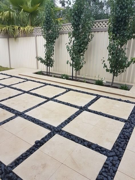 Pavers With Pebbles In Between, Pavers And Pebbles Patio, Patio With Large Pavers, Black Pavers Patio, Black Pebbles Landscape, Modern Pavers Backyard, Black Pebble Landscaping, Garden Pebbles Landscaping, Pebble Backyard