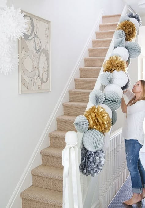 The stair banister is a traditional place for decorations. Instead of trailing greenery, go for these huge paper pom poms, festive in a slightly quirky way. As seen at House & Home. // Over-the-Top Decorating Ideas for the Hardcore Holiday Enthusiast — Minimalist/Maximalist Honeycomb Garland, Cheap Party Decorations, Moms 60th, Holiday Soiree, House Warming Party, Paper Balls, בר מצווה, 60th Birthday Party, Holiday Paper