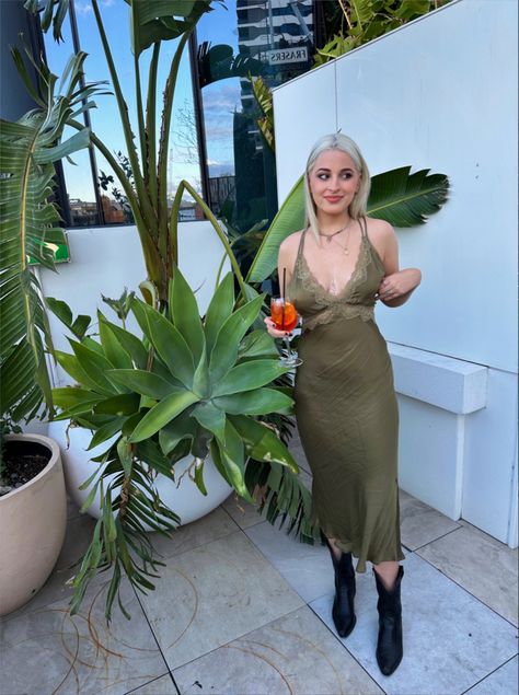 Aperol spritz cocktail hour outfit inspo fit pic Cowboy Boots Slip Dress, Slip Dress With Cowboy Boots, Slip Dress And Cowboy Boots, Green Cowboy Boots Outfit, Cocktail Dress With Boots, Dress And Cowboy Boots, Silk Skirt Outfit, Slip Dress Outfit, Green Slip Dress