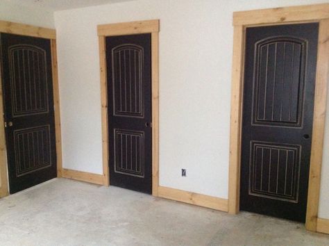 Black distressed doors with natural wood frame & trim in parent's lake house. Distressed Interior Doors, Distressed Black Interior Doors, Natural Wood Door Frame, Stained Door Frames, Modern Rustic Interior Trim, Stained Pine Trim Interior, Wood Trim Door Frame, Black Interior Doors With Stained Trim, Black Stained Doors Interior