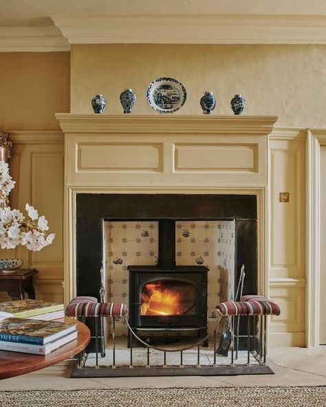 Carlos Sánchez-García on Instagram: "A fireplace in the hall of a country house I decorated. Delft tiles and an antique Persian jajim on the club fender. Photograph @horwoodphoto" Club Fender Fireplace, Delft Tile Fireplace, Delft Fireplace, Fireplace Hallway, Club Fender, Antique Bed Frame, Fireplace Fender, Fireplace Seating, Kitchen Basement