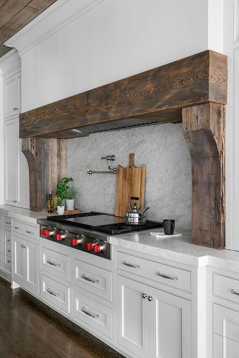 A custom white range hood is accented with reclaimed wood planks. Farmhouse Range, White Kitchen Hood, Decoration Ideas Kitchen, Kitchen Hood Ideas, Kitchen Cabinets Design, Kitchen Decoration Ideas, Kitchen Hood Design, Home Decor Ideas Bedroom, Kitchen Vent Hood