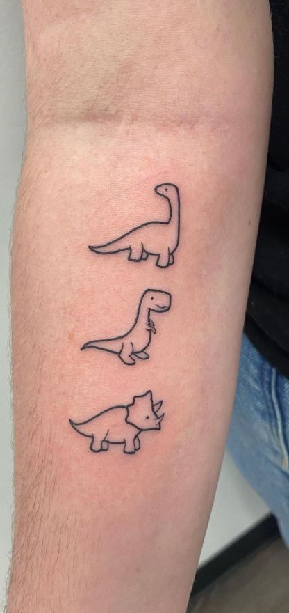 125 Dinosaur Tattoo Designs for the Dino Devotee - Tattoo Me Now Simple Tattoos Dinosaur, Trex Mini Tattoo, Small Dino Tattoos Matching, Pb And J Tattoo Best Friends, Three Dinosaur Tattoo, Dinosaur Tiny Tattoo, Fresh Tattoo Ideas, Dino Tattoos Cute, Dino Flash Tattoo