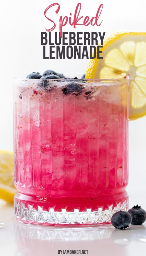 A glass full of spiked blueberry lemonade is shown, the glass is ornate, and has a lemon wheel on the edge and blueberries around it. This is all on a white counter. Blueberry Drink, Blueberry Drinks, Lemonade Juice, Homemade Lemonade Recipes, Lemonade Drink, Halloween Drinks Alcohol, Coctails Recipes, Blueberry Syrup, Blueberry Lemonade