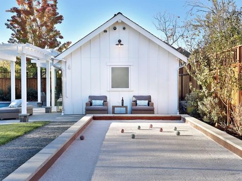 A bocce ball court is the finishing touch in making this backyard with a pool and outdoor kitchen the perfect place to throw a party. Spa Building, Yard Crashers, Farmhouse Landscape, Bocce Ball Court, Shed Makeover, Bocce Court, Valley Cottage, Bocce Ball, Victorian Farmhouse