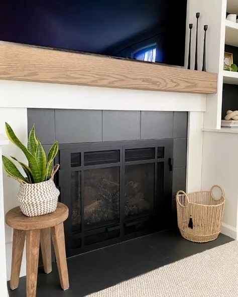 As part of this fireplace makeover, learn how to make a mantel and paint tiles to update the look of your fireplace. No Tile Fireplace, Diy Fireplace Makeover Rental, Fireplace Surrounds And Mantels Tile, Townhouse Fireplace Makeover, Tile Around Fireplace Ideas Mid Century, Diy Rental Friendly Fireplace, Diy Fireplace Refacing, Basic Tile Fireplace, Tile Pellet Stove Surround