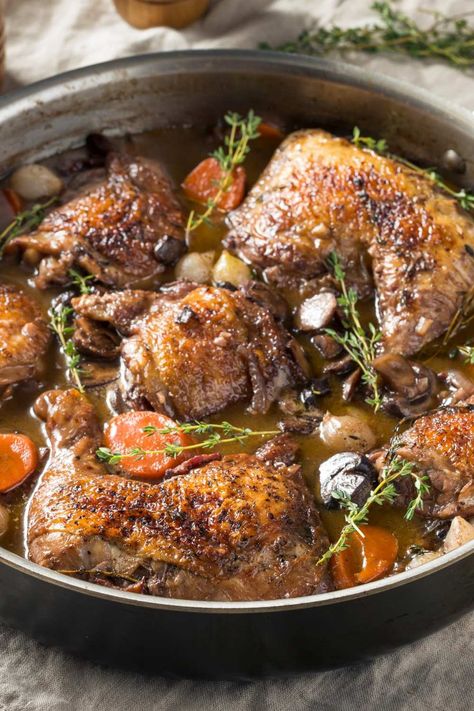 Jamie Oliver Slow Cooker Coq Au Vin is made with Pinot Noir, thick-cut bacon, chicken thighs, crimini mushrooms, shallots, garlic, carrots, chicken broth, tomato paste, fresh thyme, bay leaves, white pearl onions, unsalted butter, and flour. This hearty Slow Cooker Coq Au Vin recipe creates a hearty dinner that takes about 8 hours to prepare and can serve up to 5 people. Coq Au Vin Slow Cooker, Chicken Coq Au Vin Recipe, Slow Cooker Coq Au Vin, Mind Diet Recipes, Carrots Chicken, Coq Au Vin Recipe, Garlic Carrots, Slow Cooker Meal, Crimini Mushrooms