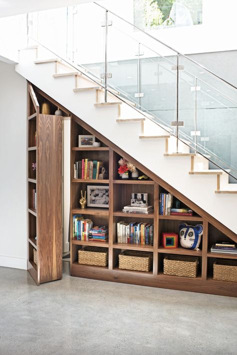 a bookshelf with books and a basket on it Door Under Stairs, Stair Bookshelf, Stairs Furniture, Architecture Room, Stair Shelves, تحت �الدرج, Murphy Door, Stairs Renovation, Staircase Storage