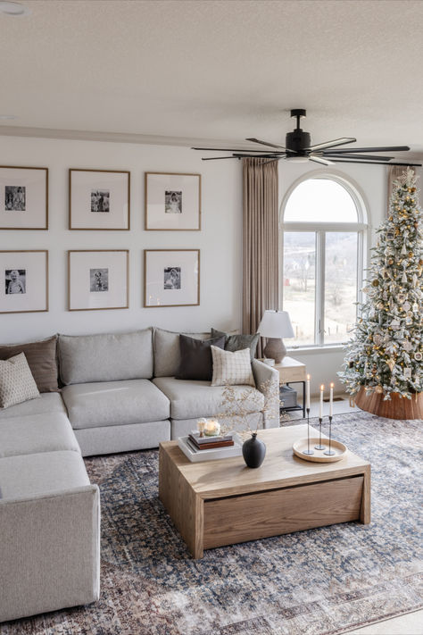 Boho neutral living room with natural lighting and Christmas tree. Grey Sectional Living Room Ideas Cozy, Sectional By Fireplace, Small Living Room Inspirations Cozy, Grey Couch Sectional Living Room, Family Room Design Sectional, Living Room Ideas White Couch, Stone Color Couch Living Room, Sectional Living Room Layout Apartments, Living Room Gray Sectional Decor