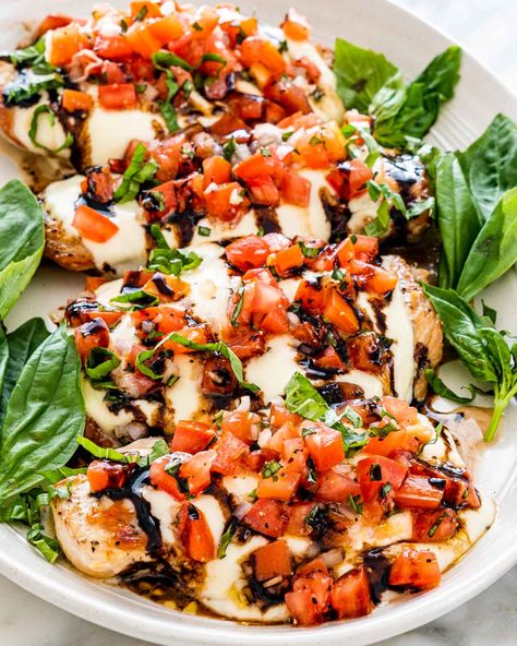 My recipe for Bruschetta Chicken is made with melty mozzarella cheese, then topped with the easiest fresh bruschetta. All that with just a few kitchen staple ingredients? You'll be welcoming this main event to your weekly rotation. #bruschetta #chicken #recipe Livy Losers, Bruschetta Chicken Bake, Chicken Bruschetta Recipe, Chicken Bruschetta, Homemade Bruschetta, Grilled Bruschetta, Jo Cooks, Bruschetta Chicken, Bruschetta Recipe