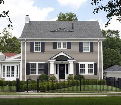 One way to tie in your exterior walls with a grey roof is to paint them a different shade of grey Tan House, Colonial House Exteriors, Shutter Colors, Best Exterior Paint, House Paint Color Combination, Exterior House Ideas, Black Shutters, House Shutters, Gray House