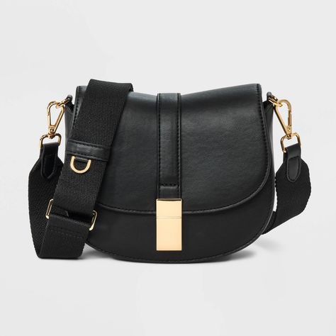 This Saddle Crossbody Bag from A New Day™ with a structured silhouette features a roomy main compartment and an interior zip pocket for easy organization of your belongings, plus an overlapping flap with a gold-tone buckle accent and magnetic closure. Plus, the detachable adjustable shoulder strap makes carrying a breeze whether you sling it over one shoulder or carry it in hand. A New Day™: Style that goes wherever you do. Soft Summer Style, Target Purse, Crossbody Bag Outfit, Saddle Crossbody Bag, Fossil Crossbody Bags, Cute Crossbody Bags, Winter Styling, Black Crossbody Purse, Winter Capsule Wardrobe