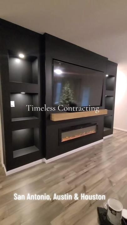 TimelessContracting on TikTok Basement Fireplace With Built Ins, Black Tv Fireplace Wall, Black Wall With Fireplace And Tv, Fireplace Wall Basement, Basement Tv With Electric Fireplace, Black Entertainment Wall, Black Fireplace And Built Ins, Black Tv Wall Design, Low Ceiling Fireplace Ideas