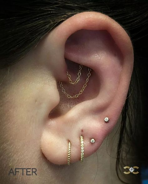 Elevate your ear game with our bespoke piercing services. We specialise in crafting unique ear curation, tailored to your individual anatomy. Our client visited us with healed Daith piercing that was sitting at an angle, and we we created this look with two draping chains! ✨💎 #LuxuryPiercing #EarCuration #PremiumJewellery #BespokeStyling Swipe for the before picture! Find Ireland's largest collection of Fine Jewellery in-store at 7 D'Olier Street or online at our webstore, link in bio! Face In Hole, Daith Piercing, Tattoos And Piercings, Ear Piercings, Piercings, Fine Jewelry, Chain, Tattoos