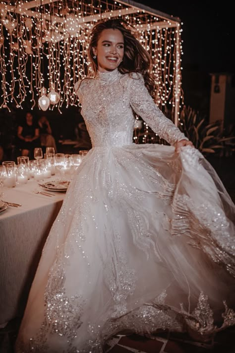 Sparkly, fully adorned wedding ball gown. Features a turtleneck bodice, semi-transparent crystal beaded long sleeves, and a full skirt with a train. Turtleneck Bride Dress, Princess Winter Wedding Dress, Wedding Dress With A Collar, Long Sleeve Full Skirt Wedding Dress, Wedding Dresses With Sleeves Sparkly, Ball Gowns Full Sleeve, Full Sleeves Wedding Gown, Long Sleeve Turtleneck Wedding Dress, Ball Gowns Wedding Dress With Sleeves