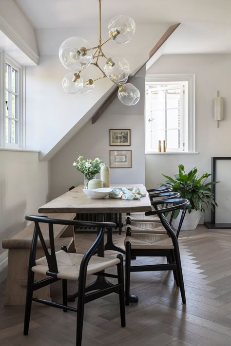 Dining table, 4 black rattan dining chairs and wooden bench in this apartment interiors. This gorgeous chandelier with 7 glass bolles and gold structure. And lets not forget this gorgeous chevron floor. #interiordesign #diningroom #formaldining Black Wood Chairs, Wishbone Chair Dining, Decor And Organization Ideas, Scandinavian Kitchens, Wooden Dining Table Designs, Table With Bench, Scandinavian Kitchen Design, Kitchen Cabinet Styles, Wood Chairs