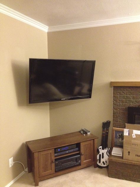 Corner mounted TV with the wires hidden adds so much space in your bedroom and gives it a nice clean look! Living Room Corner Tv Ideas, Corner Mounted Tv, Corner Tv Mount, Empty Fireplace, Corner Tv Wall Mount, Corner Tv Cabinets, Corner Tv Stands, Mount Tv, Bedroom Tv Wall