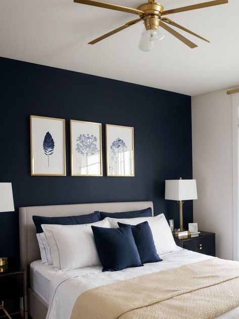 Create a striking focal point in your bedroom with navy blue wall art, complemented by a crisp white bedspread and gold accessories for a touch of elegance. Complete the look with a sleek black nightstand and modern lighting fixtures to add a contemporary feel to your space. Navy Bedroom Walls, Navy Gold Bedroom, Navy Blue Bedroom Walls, White Gold Bedroom, Grey And Gold Bedroom, Blue And Gold Bedroom, White Bedspread, Blue Bedroom Walls, Navy Blue Bedrooms