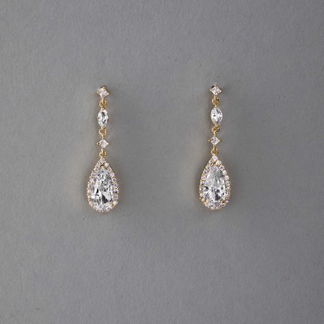 Enhance your bridal ensemble with these exquisite wedding earrings featuring a pave set elongated pear drop, delicately suspended from petite round and marquise CZ stones.They are 1.5 inches long, post pierced backs, rhodium, rose gold or gold plated, grade AAA CZ stones, lead, cadmium, and nickel free. Elegant Long Earrings Gold, Gold Dangle Earrings Wedding, Gold Crystal Earrings, Earrings Sapphire, Wedding Earings Idea, Grad Earrings, Homecoming Earrings Gold, Earring Bride, Gold Earrings For Wedding