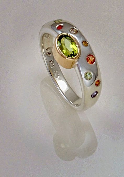 Ring offset with peridot in 9ct yelow gold on sterling silver band flush set with sapphires. miekevandamjewellery.co.nz Flush Setting Jewelry, Flush Setting Ring, Flush Setting, Silver Rings With Stones, Peridot Jewelry, Metal Clay Jewelry, Silver Jewelry Design, Modern Ring, Stone Setting