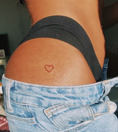 Small Heart On Hip Tattoo, Heart Tattoo Pelvis, Heart Hip Tattoos Women, Cute Placement For Small Tattoos, Red Heart Tattoo On Bum Cheek, Red Heart Tattoo On Hip, Heart On Buttcheek Tattoo, Heart Tattoo Buttcheek, Glute Tattoo