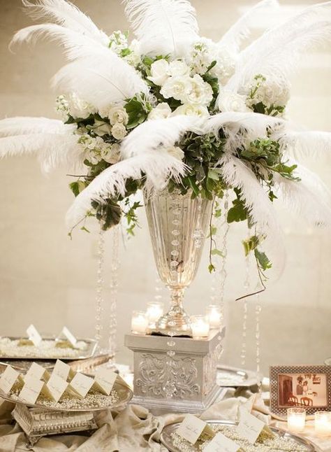 Whimsy and eye-catching decor is a characteristic feature of art deco weddings, and if you’ve chosen this theme, make every touch awesome! Art deco ... Art Deco Wedding Flowers, Art Deco Wedding Centerpieces, Art Deco Centerpiece, Art Deco Wedding Theme, 1930s Wedding, 20s Wedding, Great Gatsby Theme, Feather Centerpieces, Gatsby Theme