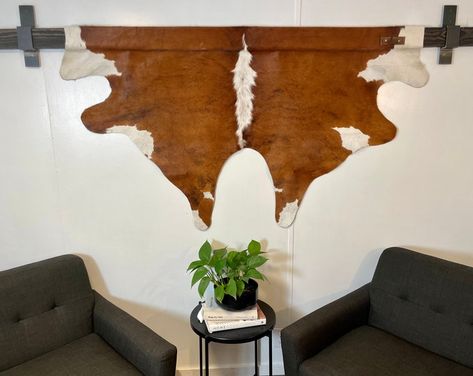 ALeatherHangs - Etsy Hang Cowhide On Wall, Cowhide Wall Decor Ideas, Goat Hide Decor, Deer Hide Wall Hanging, Animal Hide Wall Hanging, Hanging Cowhide On Wall, Cow Hide Wall Decor Ideas, Cowhide On Wall, Cowhide Wall Decor