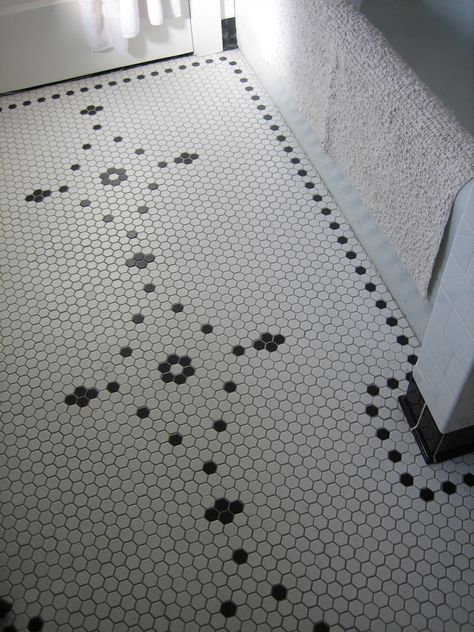 This white hex tile floor with a pretty black pattern has a vintage, feminine vibe Hexagon Bathroom Tile, Classic Bathroom Tile, Hex Tile Floor, Hexagonal Tiles, Honeycomb Tile, Vintage Bathroom Tile, Hex Tile, Penny Tile, Patterned Floor Tiles