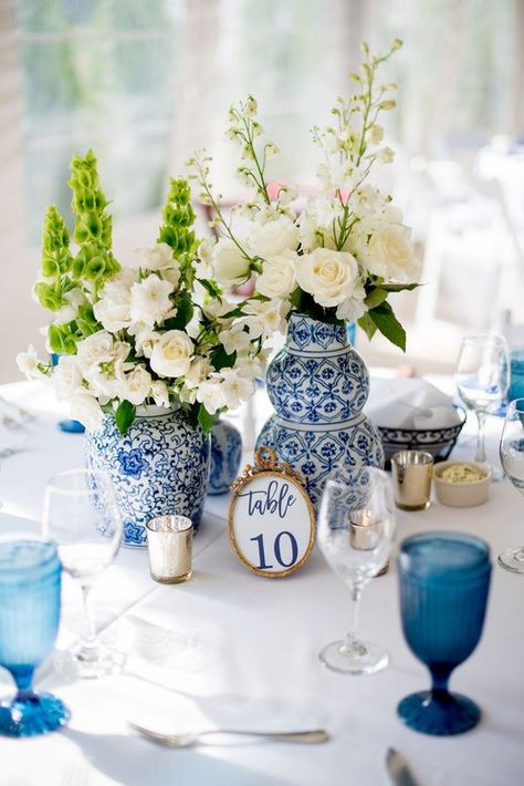 Unique Round Table Centerpieces, Blue And White Ginger Jar Wedding, Wedding Inspo Blue And White, Blue And White Table Numbers, Blue And White Wedding Theme Receptions, Blue Willow Wedding Table Settings, Blue And White Vintage Wedding, Something Blue Centerpiece, Blue And White Tropical Wedding