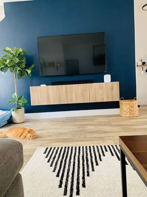 Living room, floating tv stand, dark blue Blue Wall Tv Living Room, Tv Wall Accent Color, Dark Accent Wall Living Room Tv, Blue Tv Wall Living Room, Navy Blue Accent Wall Living Room Tv, Dark Blue Tv Wall, Navy Blue Tv Wall, Blue Themed Living Room Ideas, Tv Wall Color Ideas Living Room